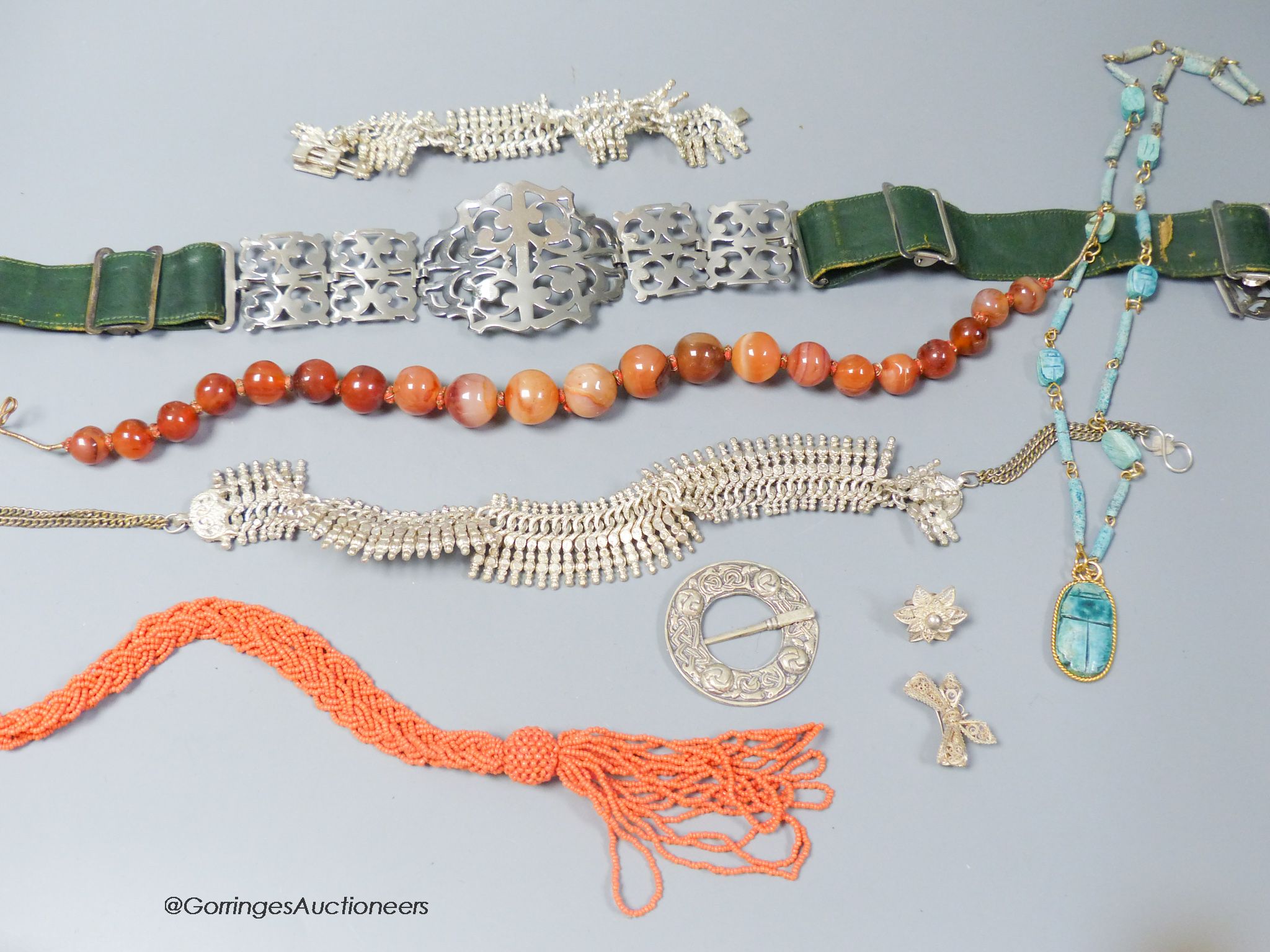 A silver plate mounted belt and minor jewellery including an agate bead necklace and a coral bead necklace.